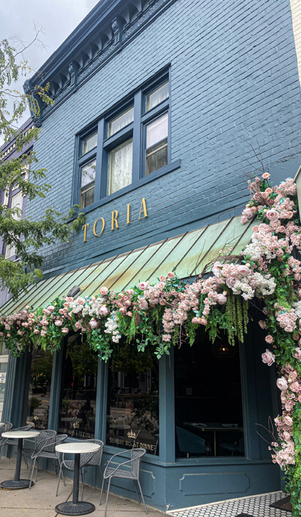 Charming café with floral decor and outdoor seating.