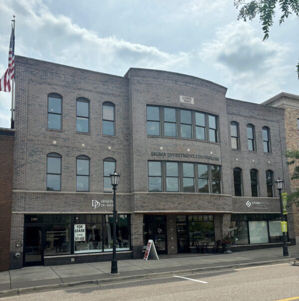 Brick building with various business signs.